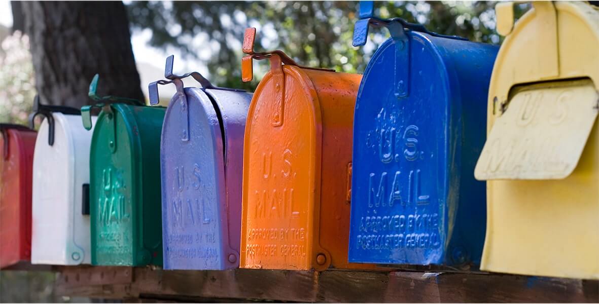 A row of mailboxes in different colors.