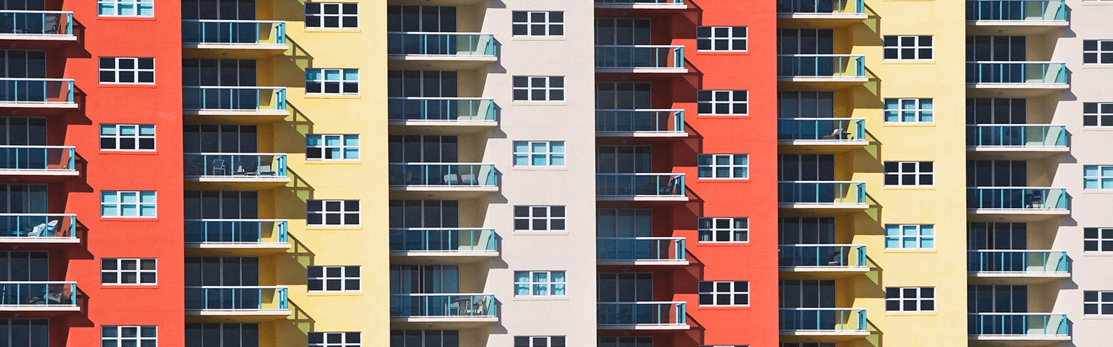 A multicolor apartment building with outdoor decks.