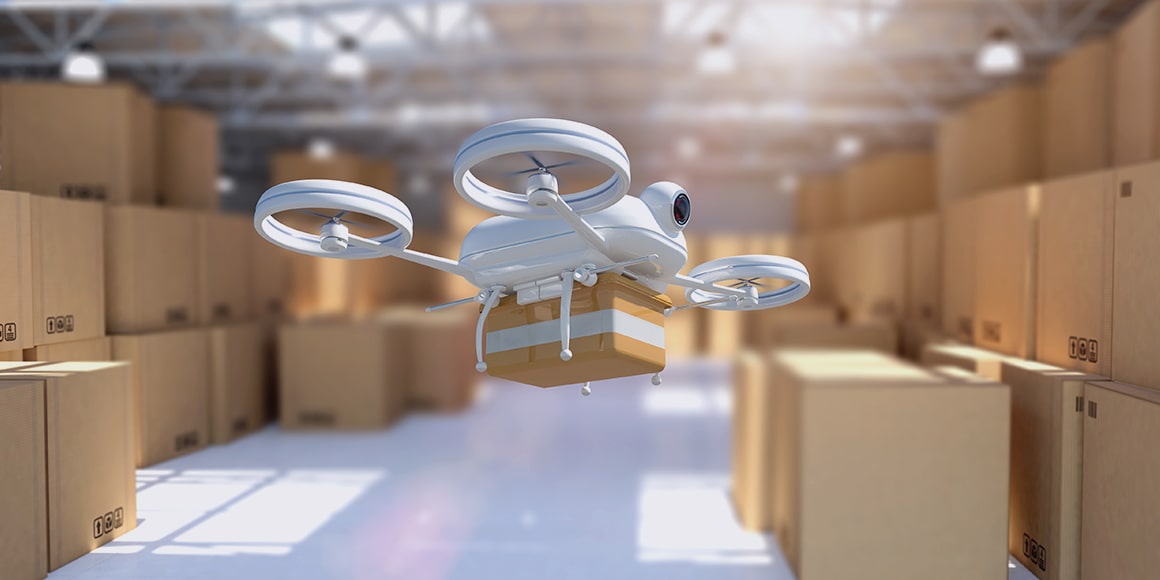 A drone carrying a package in a warehouse.