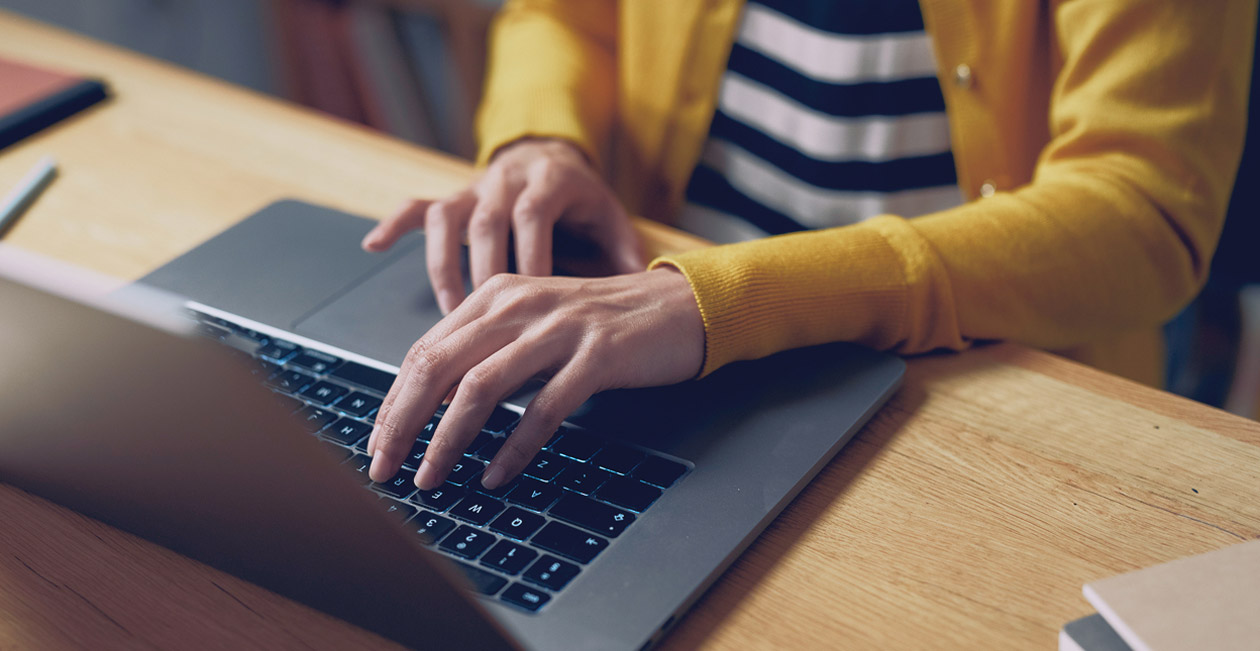 A person typing on a laptop