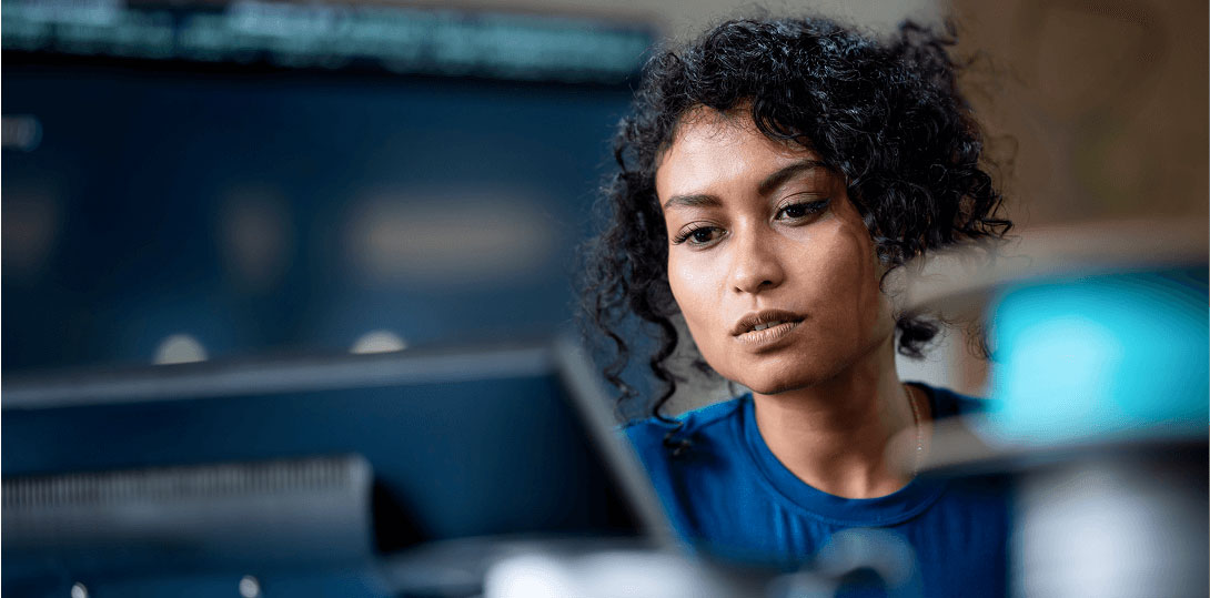 A woman working intently on her computer.